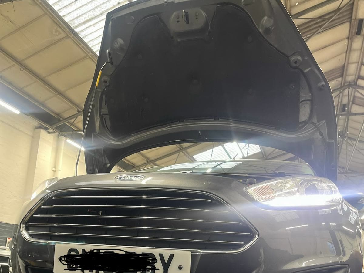 Ford inspection in Rainham with the bonnet open on a workshop ramp before repair advice