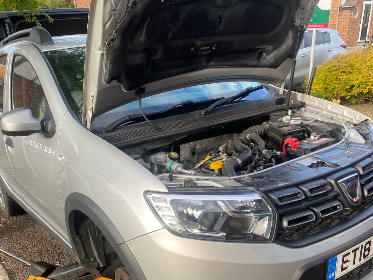 Starter motor replacement in Elm Park on a Dacia Sandero Stepway with the bonnet open
